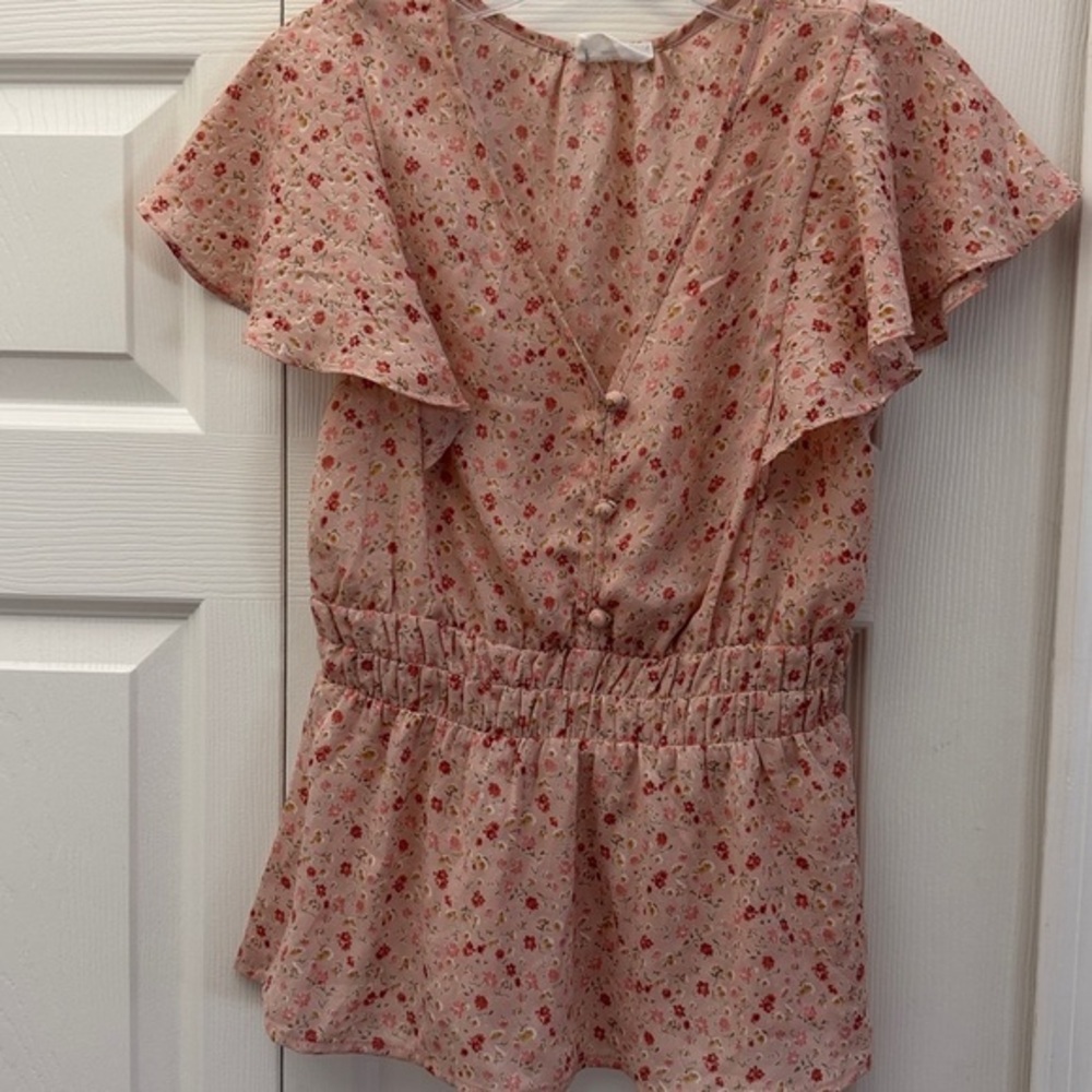 Sienna Sky Blouse, silky V-neck, short sleeves, and an elastic waist.